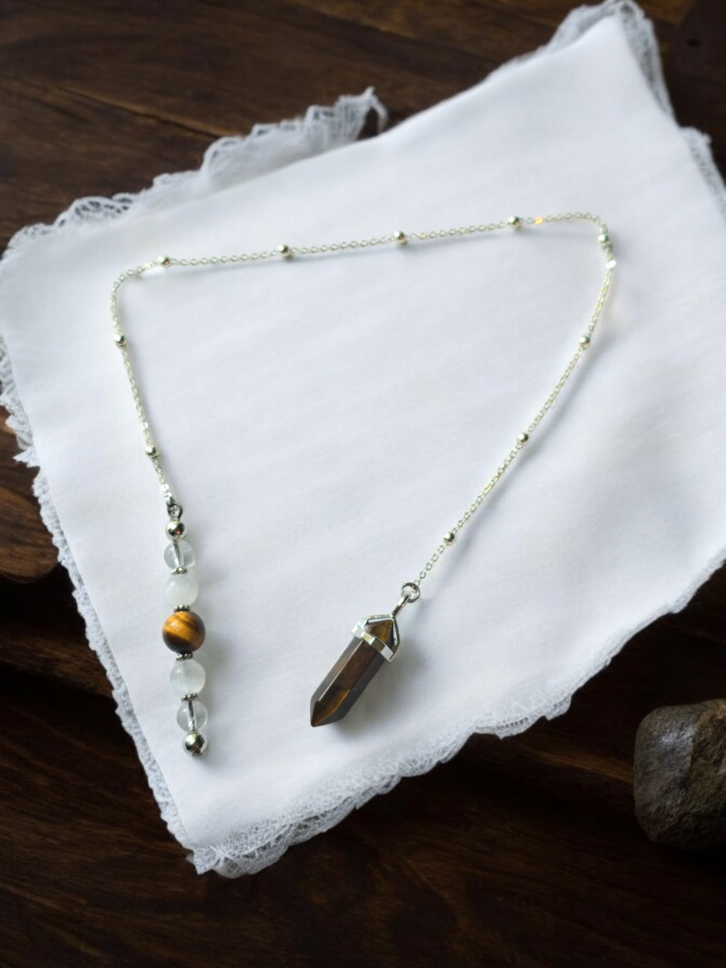 Tiger eye, selenite and clear quartz crystal pendulum with beaded chain.