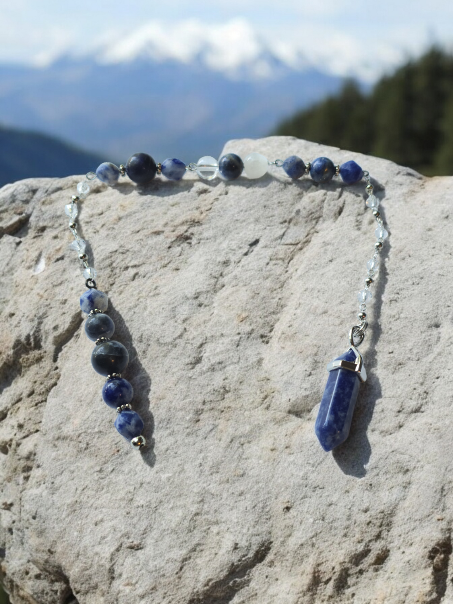 Sodalite, selenite and clear quartz crystal pendulum with beaded chain.