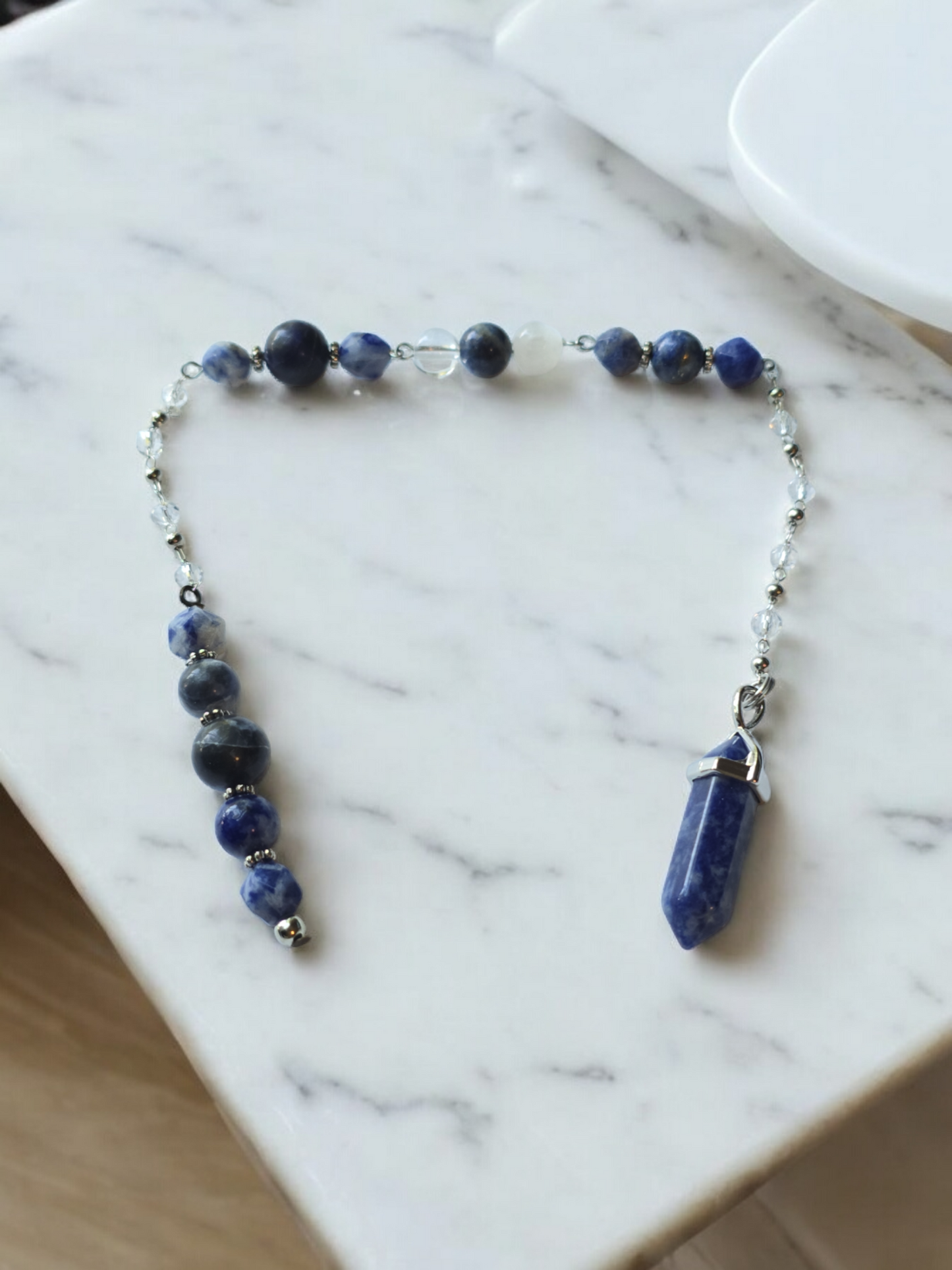 Sodalite, selenite and clear quartz crystal pendulum with beaded chain.