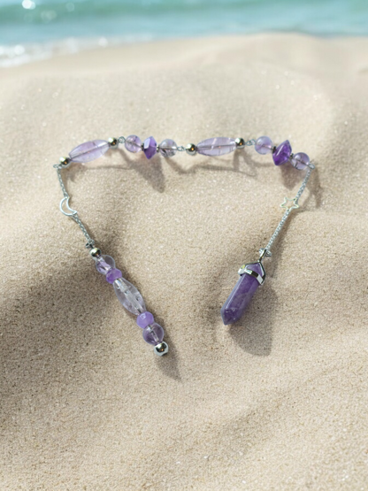 Amethyst crystal pendulum with beaded chain.