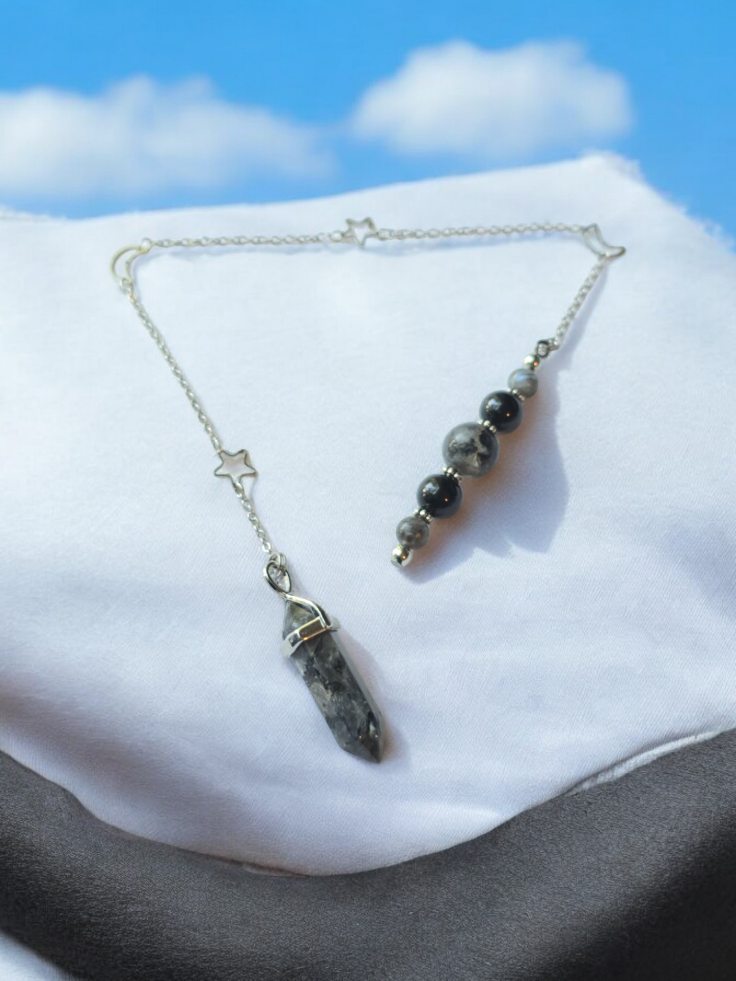 Larvikite crystal pendulum with moon and star chain.