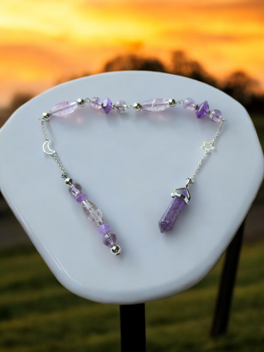 Amethyst crystal pendulum with beaded chain.