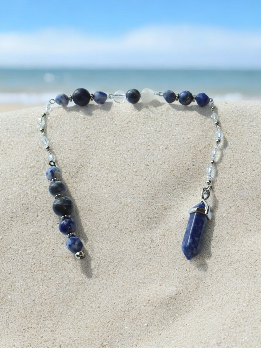 Sodalite, selenite and clear quartz crystal pendulum with beaded chain.