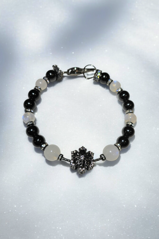 Little black dress holiday bracelet with Black metal fidget Snowflake, focal and obsidian, and moonstone beads with bling spacers and heart clasp.